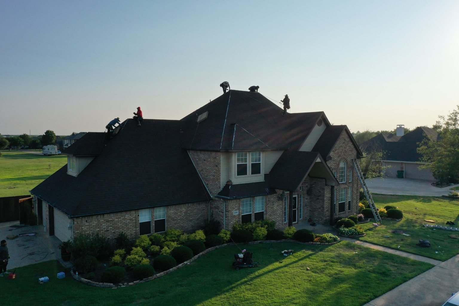 Roofing crew working on home